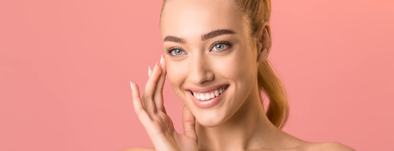 a girl smiling after having a successful treatment with candela gentlemax pro plus for skin tightening